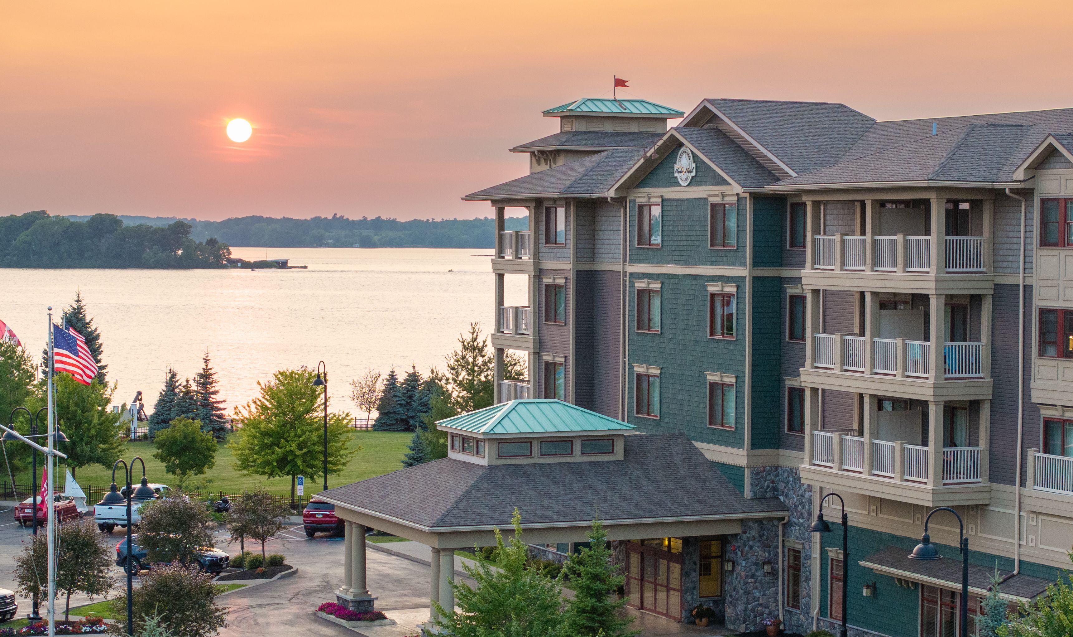 The entryway to the 1000 Islands Harbor Hotel with a beautiful sunset in the background