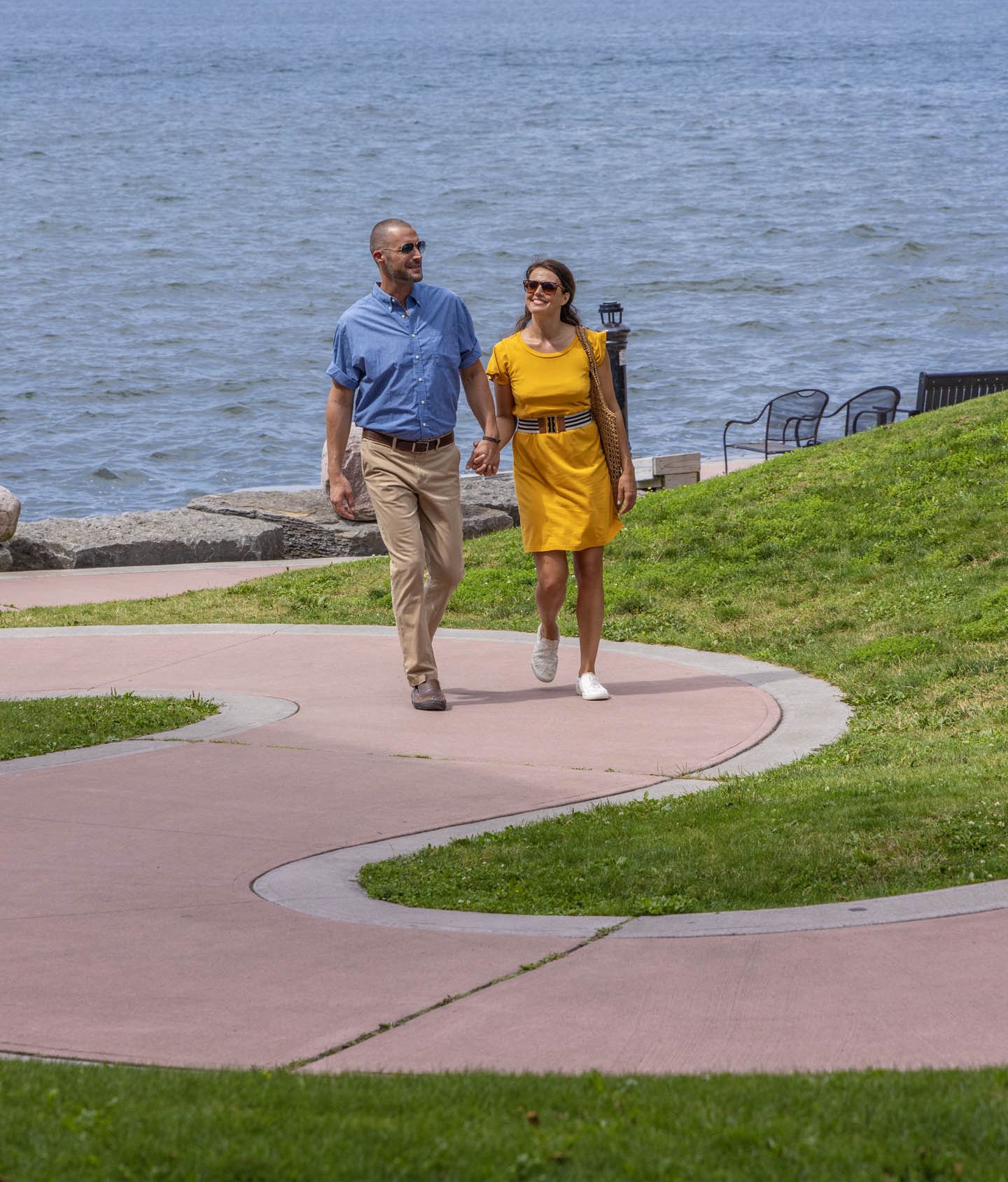 A couple walks along the riverfront boardwalk at 1000 Islands Harbor Hotel