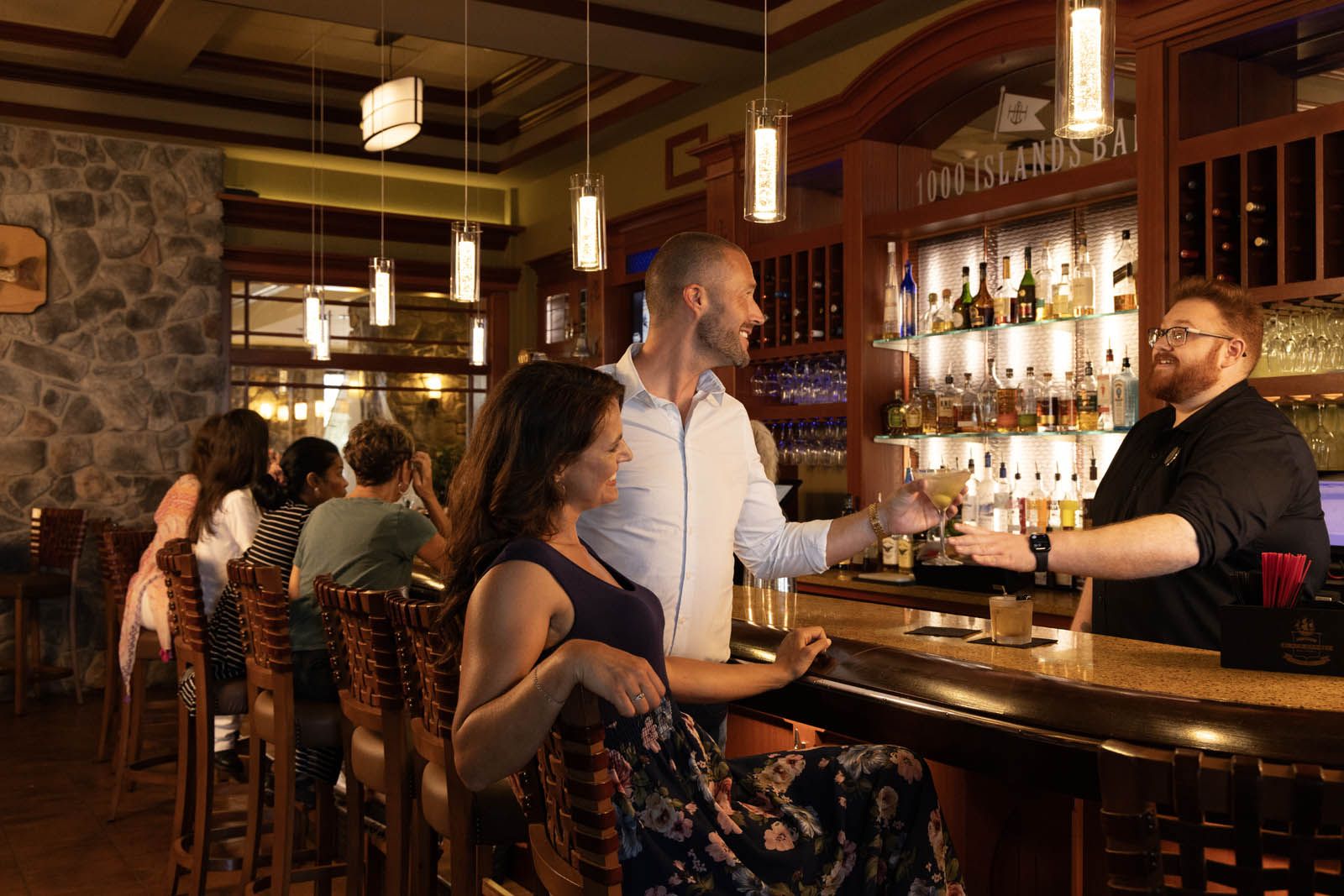 A man and woman being served drinks at The 1000 Islands Bar