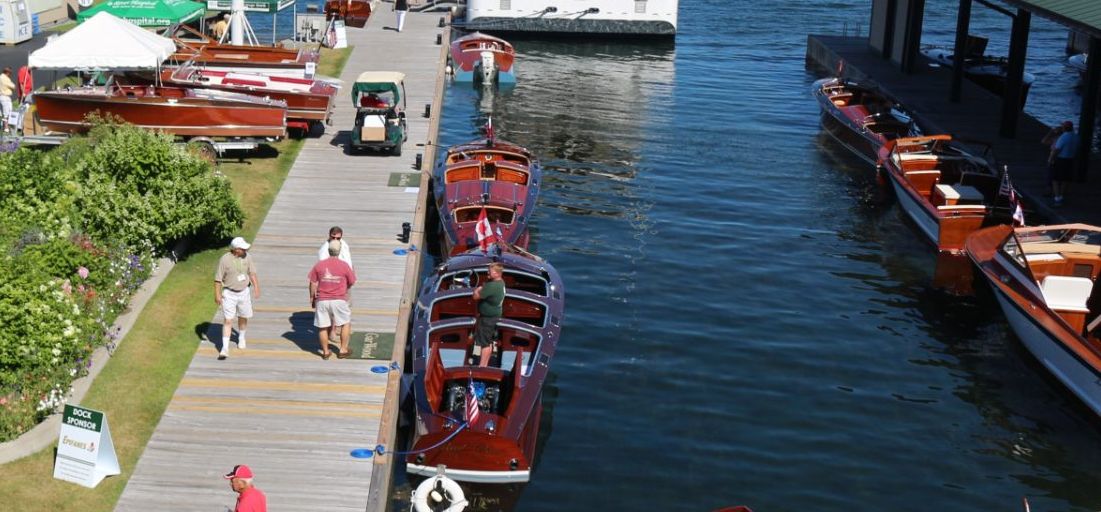 People walk along the docks at the Antique Boat Museum on the St Lawrence River