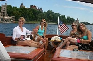 Four women on boat with American flag