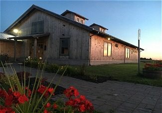 Distillery with red flowers in frame